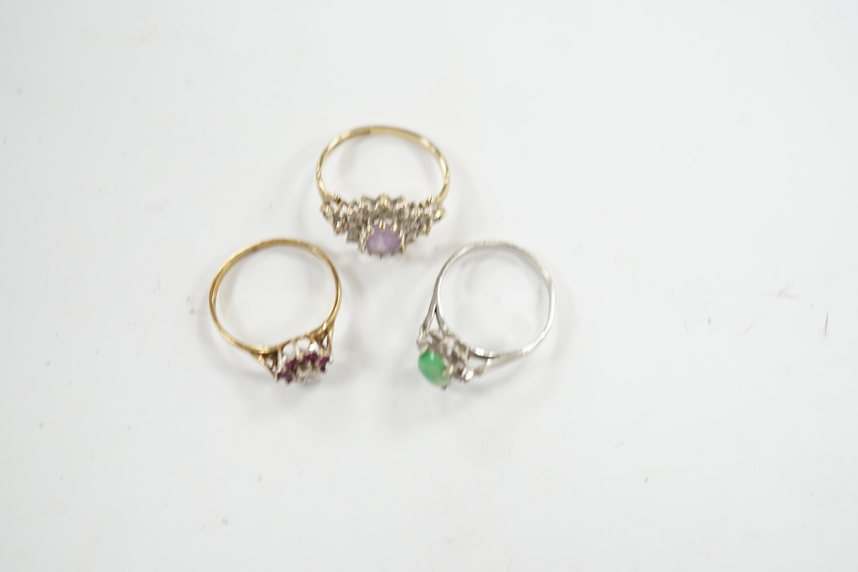 A mid 20th century 18k, jade and diamond cluster set ring, size I, gross weight 1.5 grams, together with two modern 9ct gold and gem set rings, gross weight 3.2 grams. Condition - fair